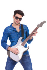 Obraz premium portrait of a young guitarist playing an electric guitar