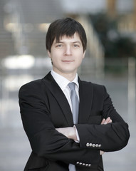 portrait of successful businessman on blurred background office.