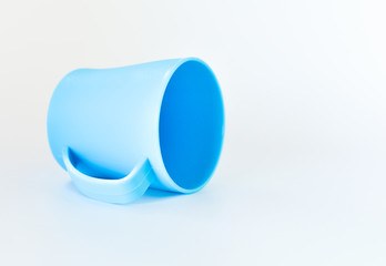 blue plastic mug isolated on white background. selective focus.