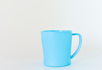 blue plastic mug isolated on white background. selective focus.