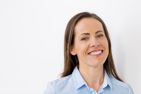 people, portrait and business concept - face of happy smiling middle aged woman or office worker