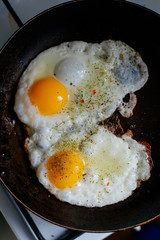 Fried eggs for breakfast early in the morning. Scrambled eggs with spices.