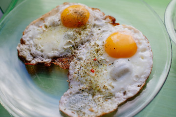 Fried eggs for breakfast early in the morning. Scrambled eggs with spices.