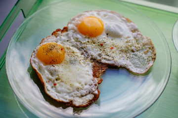 Fried eggs for breakfast early in the morning. Scrambled eggs with spices.