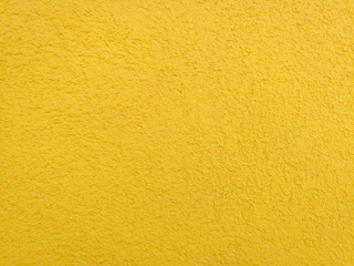 yellow background, wall with roughcast