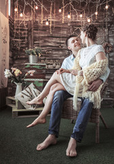 concept of happiness is a happy wife sitting on the lap of her husband