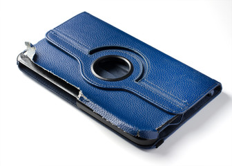 Old torn blue tablet case. White background. Close up