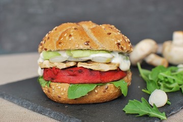 Vegan burger with beetroot, arugula, onion, mushrooms, avocado.