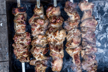 Grilled kebab cooking on metal skewers (grill).