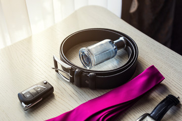 different accessories of a businessman for creating a style of a people lie on a wooden background
