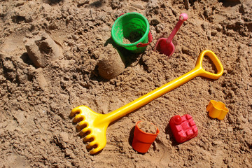 Fototapeta na wymiar Childrens toys in a sandbox
