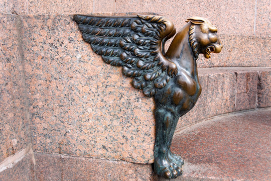 Bronze grifon on granite embankment of St. Petersburg. 