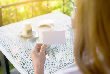 The white business card and a girl in a coffee shop with a relaxing day