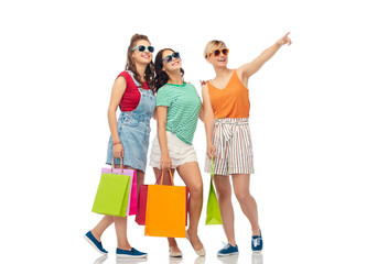 sale, friendship and people concept - happy smiling female friends shopping bags over white background