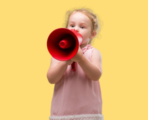 Lovely blonde toddler shouting through megaphone