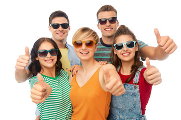 friendship, summer and people concept - group of happy smiling friends in sunglasses showing thumbs up over white background