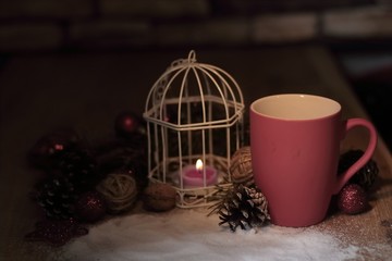 closeup.red Cup and candle at the Christmas holiday table