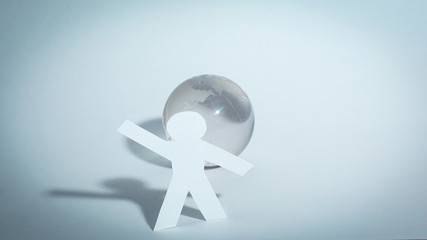 stylish paper man standing near the globe