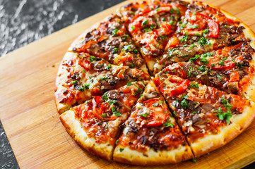 sliced Pizza with Mozzarella cheese, mushrooms, Tomatoes, pepper, Spices and Fresh Basil. Italian pizza.