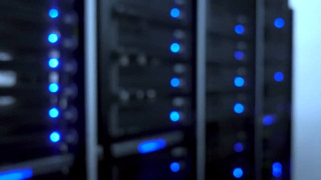 Data center, server room in a blurry background. Blinking blue led ligts 