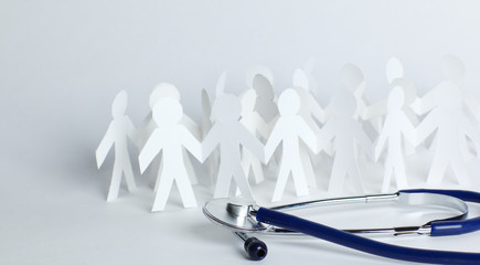 stethoscope and paper men on the table.