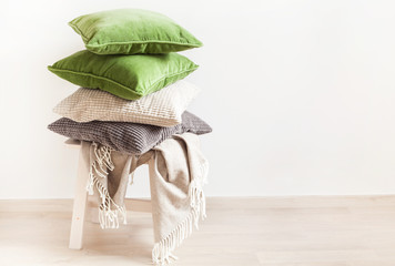 gray and green cushions, throw. cozy home