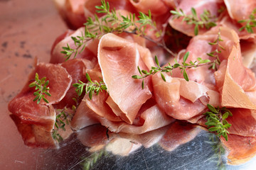 Italian prosciutto crudo or jamon with thyme .