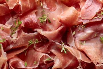 Italian prosciutto crudo or jamon with thyme.