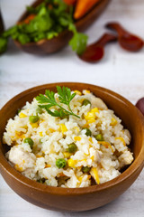 Boiled rice with vegetables in a wooden bowl