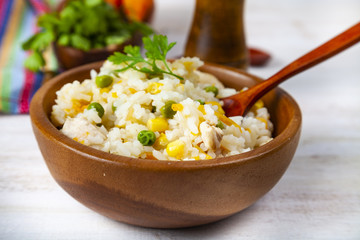 Boiled rice with vegetables in a wooden bowl