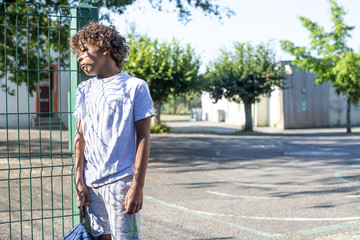 Young sad boy left alone at school. Bullied and no friends