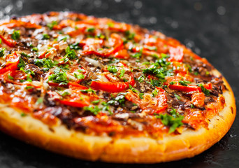 Pizza with Mozzarella cheese, mushrooms, Tomatoes, pepper, Spices and Fresh Basil. Italian pizza.