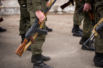 A Kalashnikov rifle in the hands of the military. War in Ukraine. Anti-terrorist operation in Ukraine. ATO in Ukraine. Armed forces.