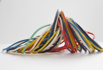 Colored stationery rubber bands on a white background