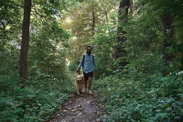 Handsome man walking his dog in outdoors