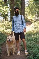 Handsome man walking his dog in outdoors