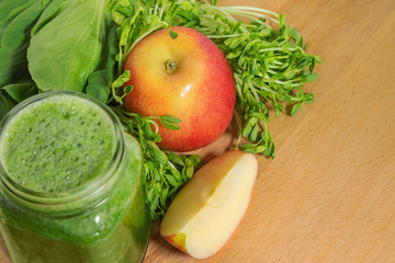 Smoothie for weight loss in a mason jar with ingridientes on a w