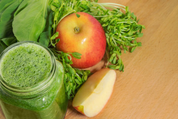 Smoothie for weight loss in a mason jar with ingridientes on a w