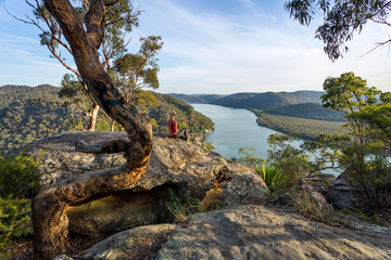 Woman chillaxing with river views in Australian bushland