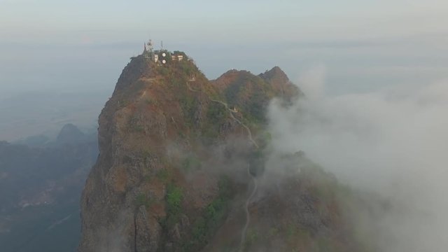 Drone shot: Mt Zwegabin during sunrise partly covered in clouds