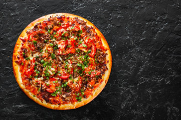 Pizza with Mozzarella cheese, mushrooms, Tomatoes, pepper, Spices and Fresh Basil. Italian pizza. on black background. with copy space. top view