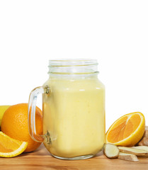 Tonifiyng smoothie in a mason jar with ingridientes on a wooden