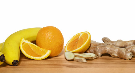 Fruits for tonifiyng smoothies on a wooden cutting board with wh