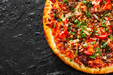Pizza with Mozzarella cheese, mushrooms, Tomatoes, pepper, Spices and Fresh Basil. Italian pizza. on black background. with copy space. top view