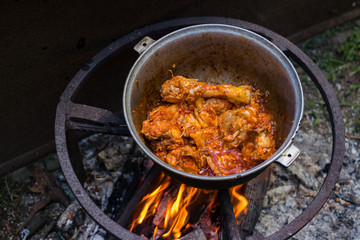 Cooking Harcho or Kharcho traditional Georgian soup food in Mingrelia with beef or chicken decorated with fresh chopped coriander leaves. Making kharcho in kettle on open fire. Georgia Samegrelo food