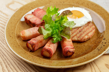 English breakfast. Fried egg and bacon rolls close up