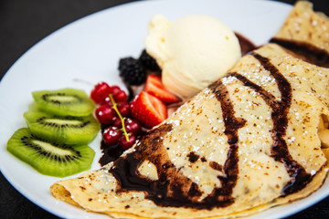 Fresh fruits mix with vanilla ice cream and crepe.