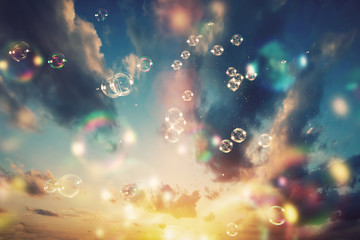 Floating soap bubbles and a sunset sky