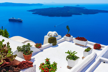 Santorini island, Greece: Landmark detail of a terrace decorated with flowers over the caldera...