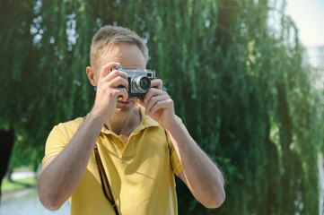 The man is photographing an old camera.